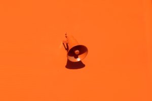 Orange speaker on a wall in an article about marketing trends.