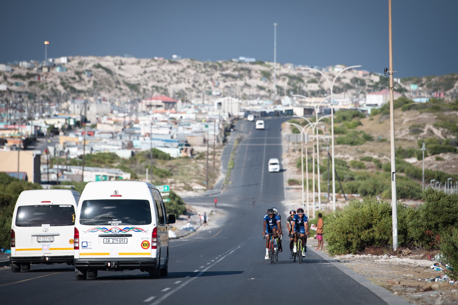 Velokhaya cyclists passing taxis on their cycle.